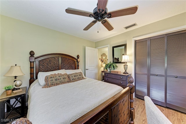 bedroom featuring a closet, ceiling fan, and light wood-type flooring