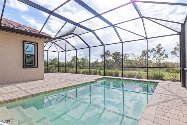 view of pool featuring a patio area and a lanai