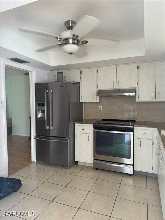 kitchen with white cabinetry, ceiling fan, stainless steel appliances, tasteful backsplash, and light wood-type flooring