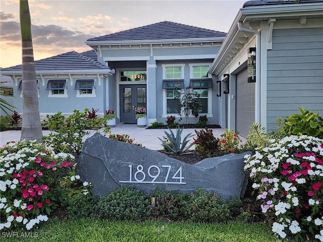 exterior entry at dusk with a garage