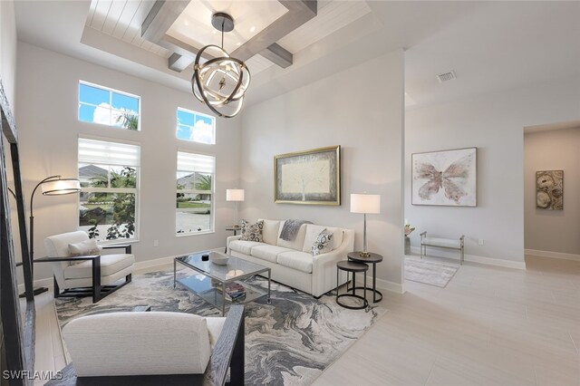 living room with a high ceiling and a tray ceiling