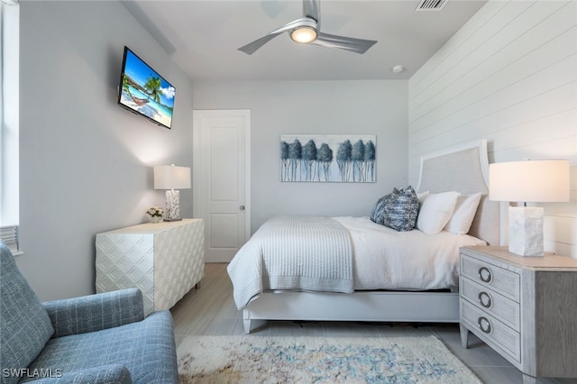 tiled bedroom featuring ceiling fan