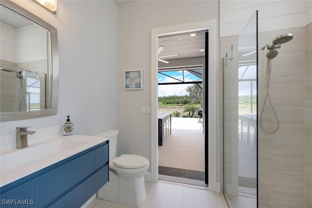 bathroom featuring tile patterned floors, toilet, and a tile shower