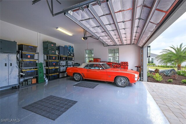 garage with a garage door opener and a carport