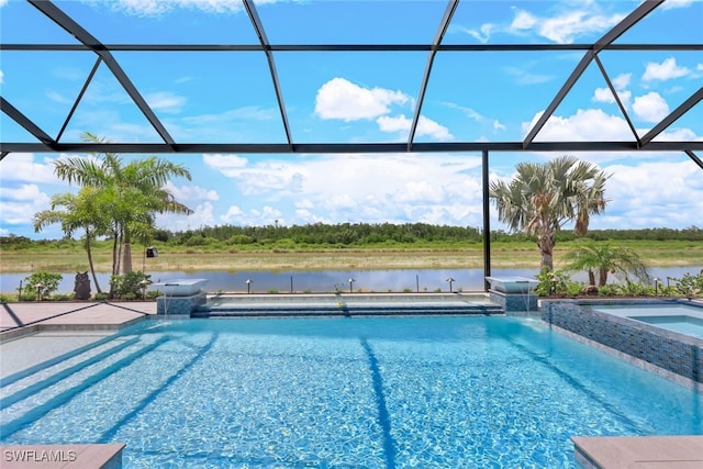 view of pool featuring a water view, glass enclosure, and a patio