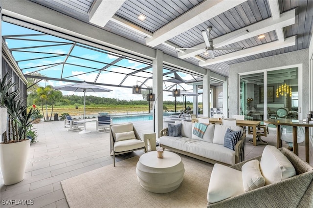 view of patio with glass enclosure, outdoor lounge area, and ceiling fan