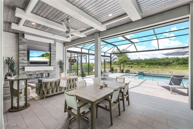 view of patio / terrace featuring glass enclosure and ceiling fan