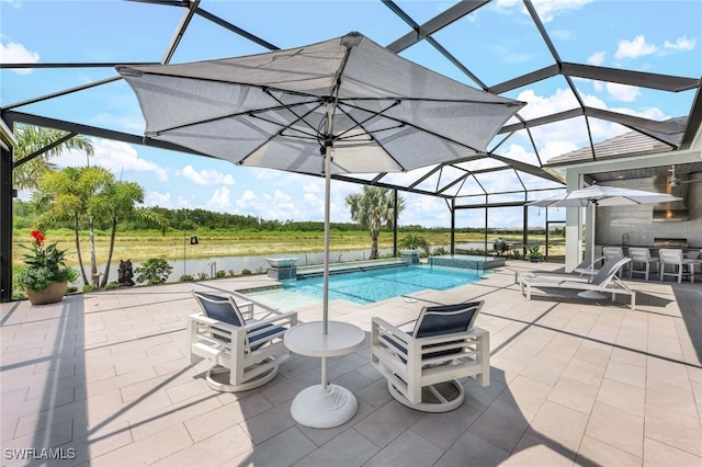 view of pool with glass enclosure, a patio area, a water view, and a bar