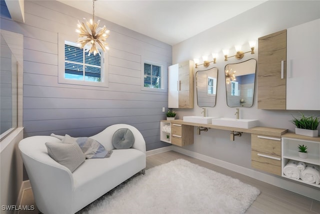 bathroom featuring wood walls, plenty of natural light, vanity, and hardwood / wood-style floors