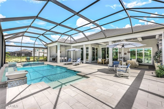 view of swimming pool featuring a patio, a lanai, and ceiling fan