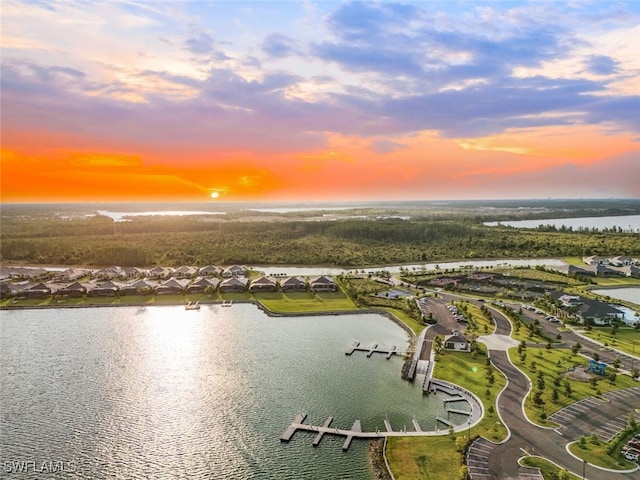 aerial view at dusk with a water view