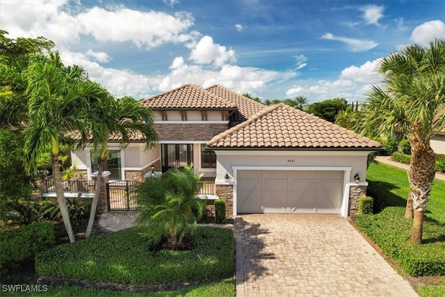 mediterranean / spanish home featuring a garage and covered porch