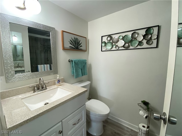 bathroom with vanity, hardwood / wood-style floors, curtained shower, and toilet