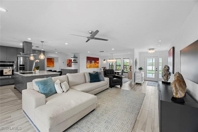 living room with light hardwood / wood-style floors and ceiling fan