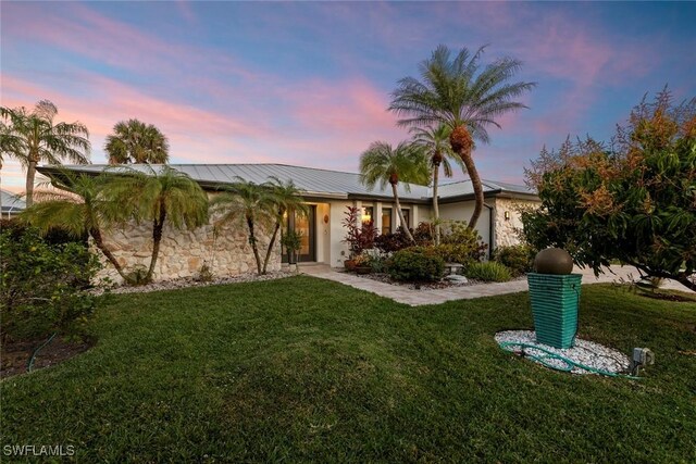 ranch-style house featuring a yard