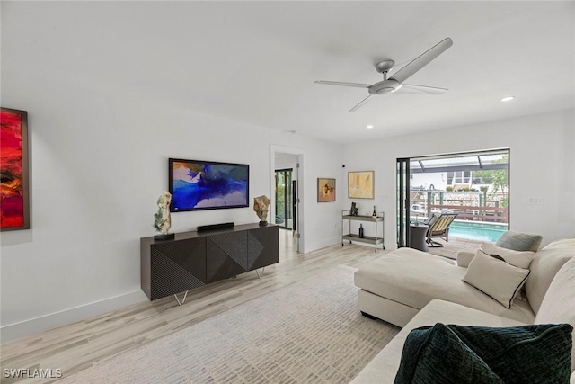 living room featuring ceiling fan and light wood-type flooring