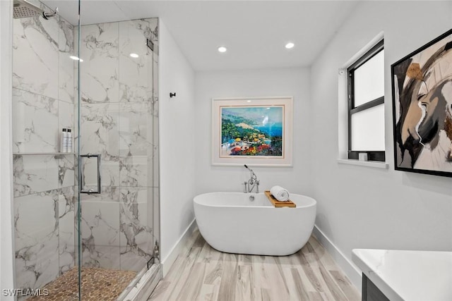 bathroom with vanity, plus walk in shower, and hardwood / wood-style floors