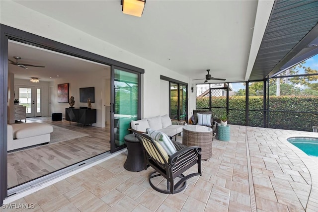 view of patio featuring a lanai, an outdoor hangout area, and ceiling fan