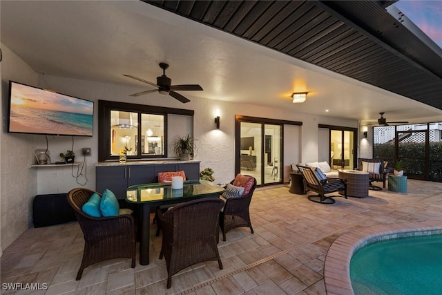 patio terrace at dusk featuring an outdoor hangout area and ceiling fan