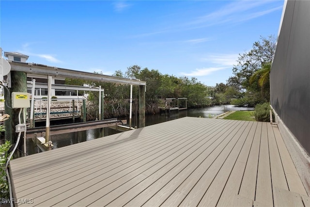 wooden deck with a water view and a dock