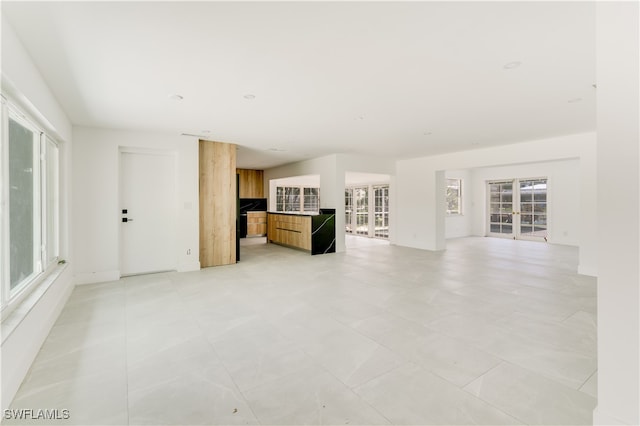 unfurnished living room with light tile patterned floors