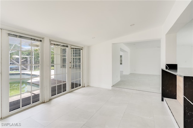 unfurnished room featuring light tile patterned floors