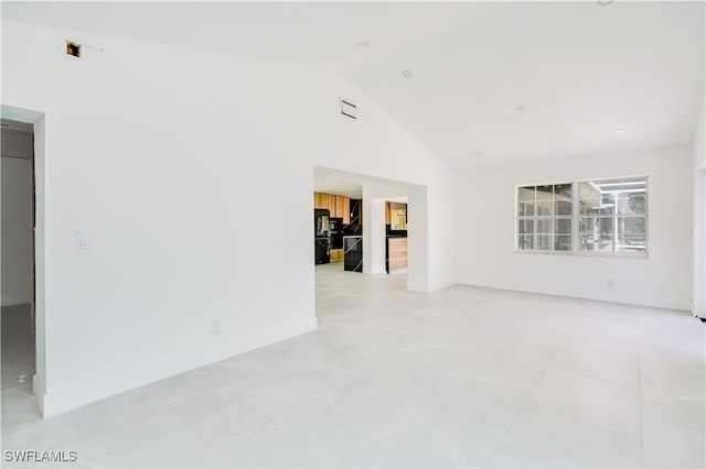 spare room featuring high vaulted ceiling