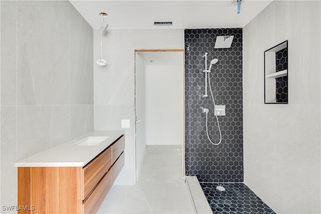 bathroom featuring vanity and tiled shower