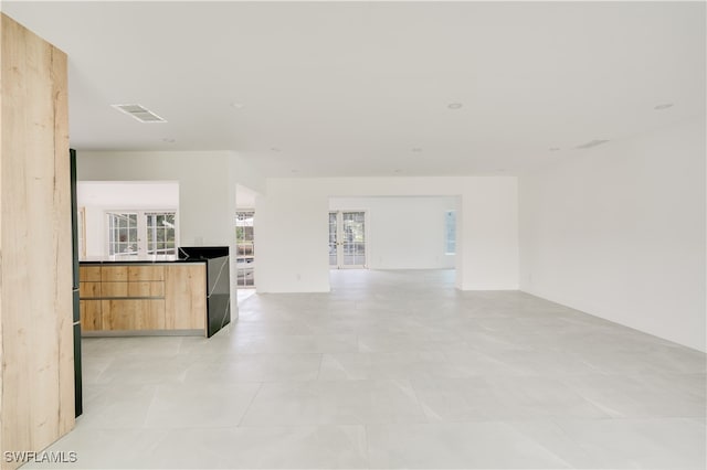 unfurnished living room featuring light tile patterned floors