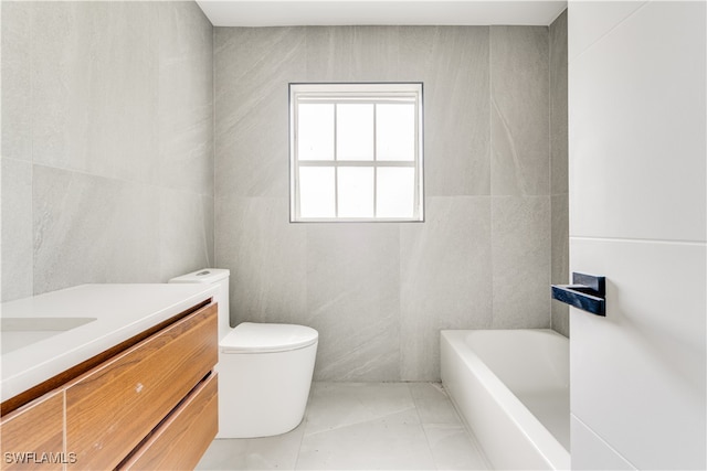 bathroom with vanity, tile walls, toilet, and a bathing tub