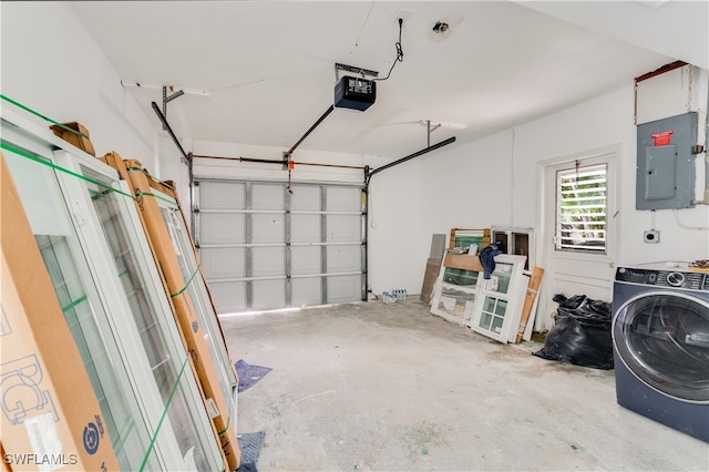 garage featuring electric panel, a garage door opener, and washer / clothes dryer