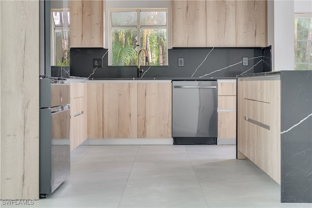 kitchen with light brown cabinetry, dishwasher, decorative backsplash, and a healthy amount of sunlight