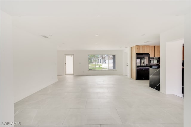 unfurnished living room with light tile patterned flooring