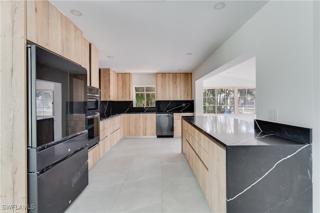 kitchen featuring light brown cabinets, tasteful backsplash, stainless steel appliances, and light tile patterned floors