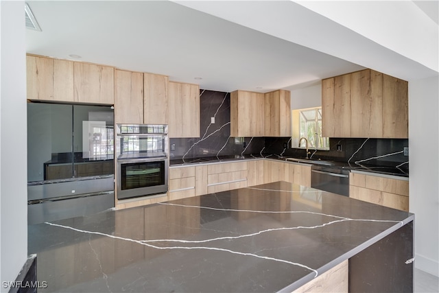 kitchen with sink, light brown cabinets, appliances with stainless steel finishes, and tasteful backsplash