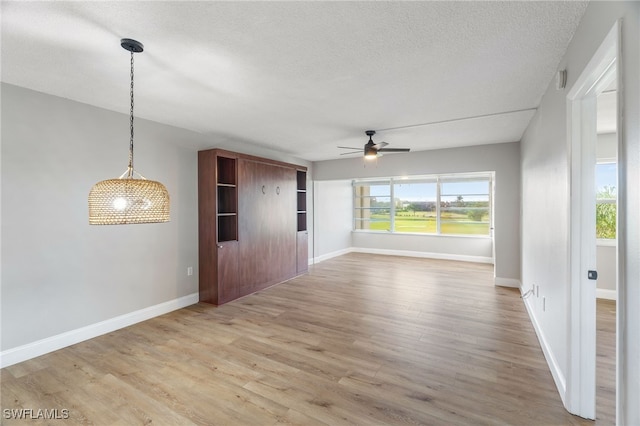 1660 Pine Valley Dr Unit 203, Fort Myers, FL 33907 - empty room with ceiling fan, wood finished floors, baseboards, and a textured ceiling