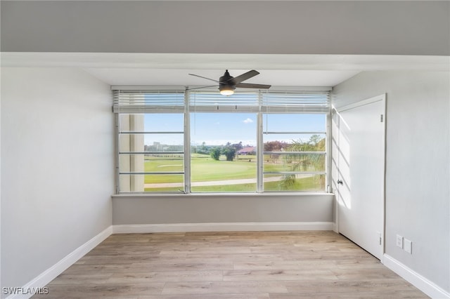 1660 Pine Valley Dr Unit 203, Fort Myers, FL 33907 - empty room featuring ceiling fan, light wood-style floors, golf course view, and baseboards