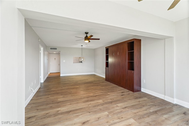 spare room featuring light hardwood / wood-style floors and ceiling fan