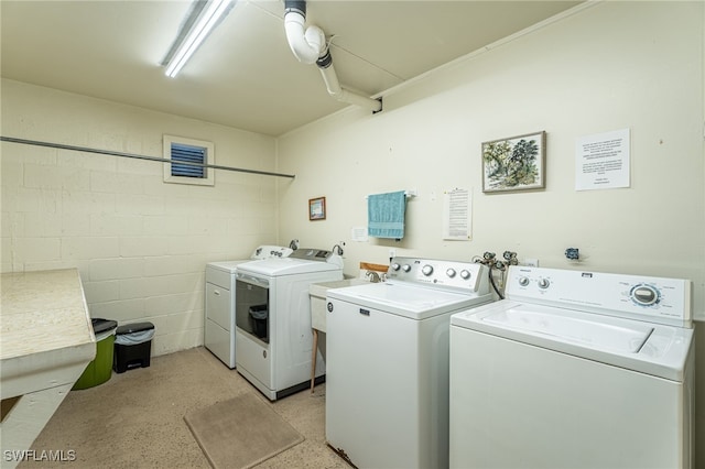1660 Pine Valley Dr Unit 203, Fort Myers, FL 33907 - laundry room featuring washer and clothes dryer and concrete block wall
