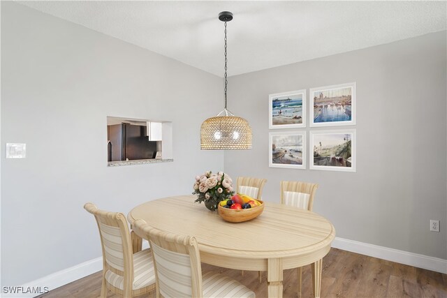 dining area with hardwood / wood-style floors