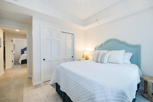 bedroom featuring a closet and light hardwood / wood-style flooring