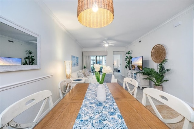 dining area with hardwood / wood-style floors, ceiling fan, and crown molding