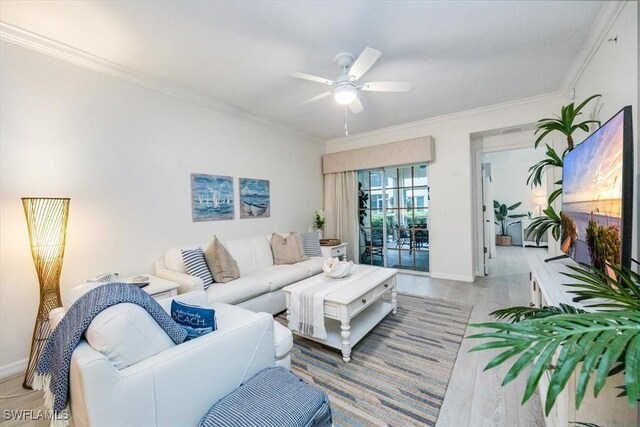 living room featuring light wood-type flooring, ceiling fan, and crown molding