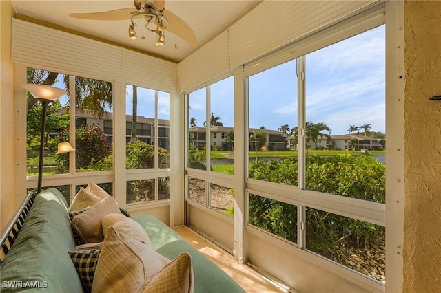 sunroom featuring ceiling fan and plenty of natural light