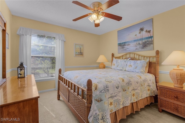 bedroom with ceiling fan and light carpet