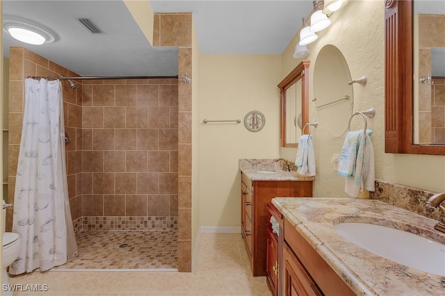 bathroom featuring vanity, tile patterned floors, and a shower with curtain