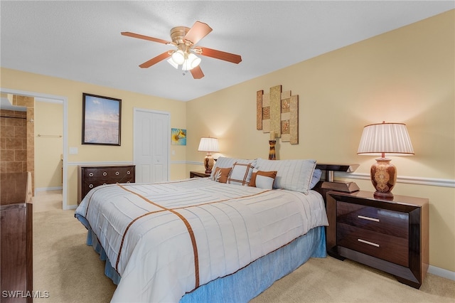 carpeted bedroom featuring ceiling fan and a closet