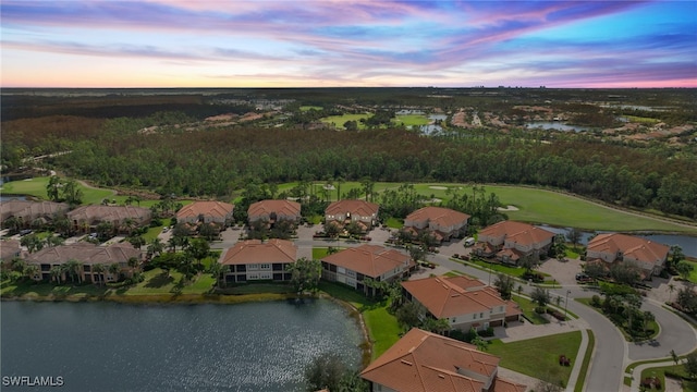 aerial view at dusk with a water view