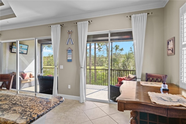 doorway featuring ornamental molding, plenty of natural light, and light tile patterned floors