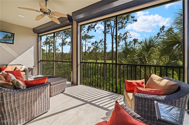 sunroom featuring ceiling fan